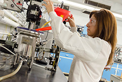 A woman working on a machine. Links to Beneficiary Designations